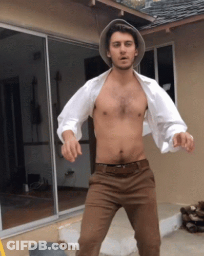 Shirtless Man Standing In Front Of House GIF