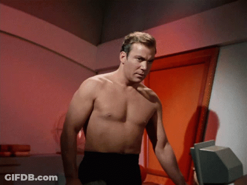 Shirtless Man Standing In Front Of Red Door GIF