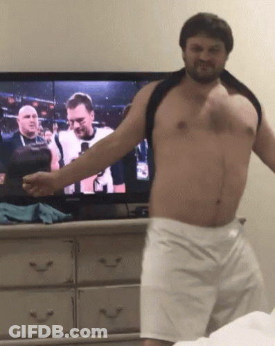 Shirtless Man Standing In Front Of TV GIF