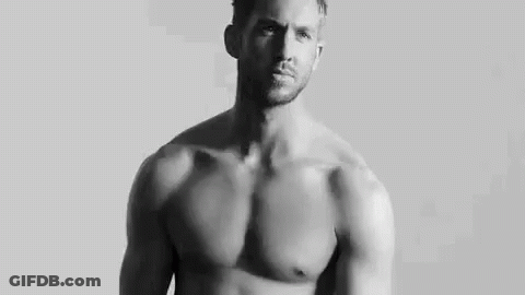Shirtless Man Standing In Front Of White Wall GIF