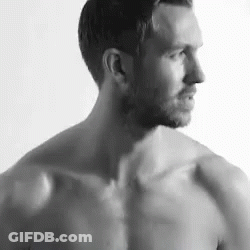 Shirtless Man Standing In Front Of White Wall GIF