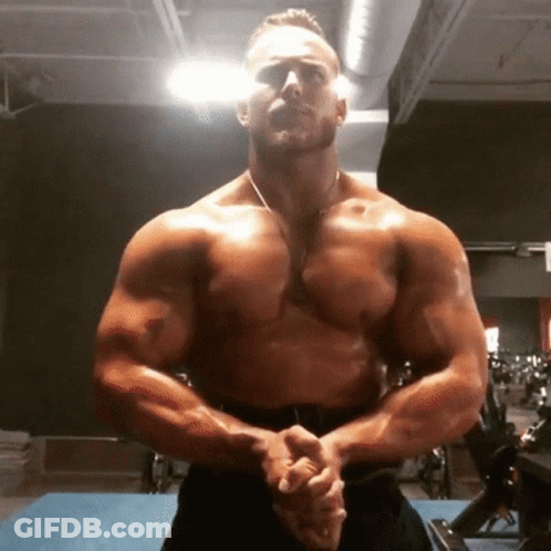 Shirtless Man Standing In Gym With Arms Crossed GIF