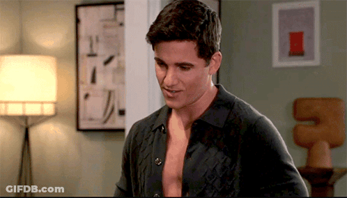 Shirtless Man Standing In Room With Lamp GIF