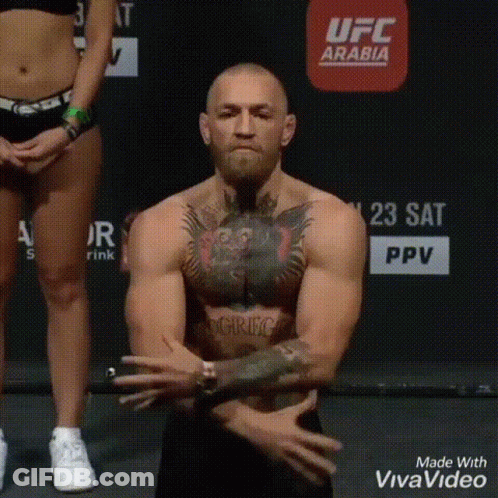 Shirtless Man Standing On Scale Hands Folded GIF