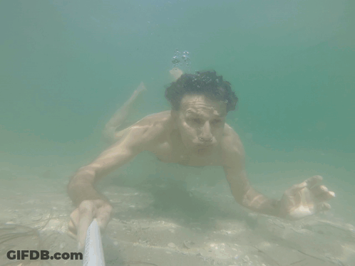 Shirtless Man Swimming Underwater Holding Rope GIF
