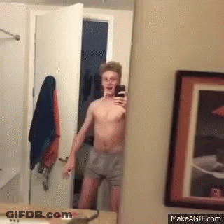 Shirtless Man Taking Selfie In Mirror GIF