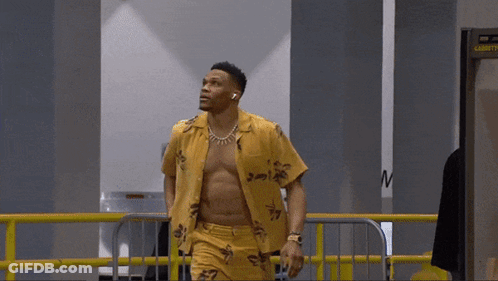 Shirtless Man Walking Through Security Checkpoint GIF