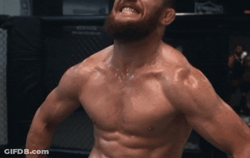 Shirtless Man With Beard In Front Of UFC Sign GIF