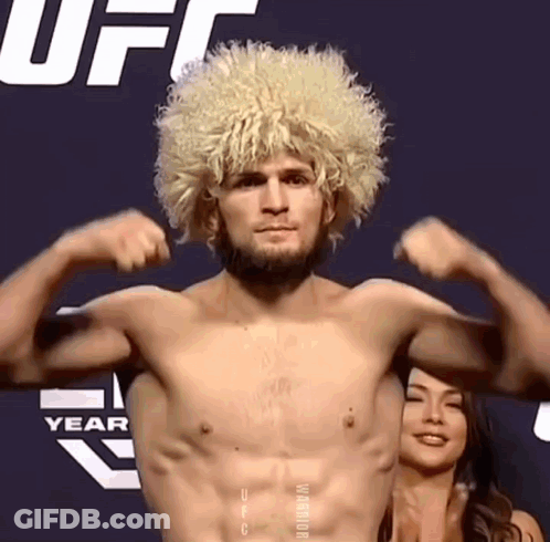 Shirtless Man With Blonde Wig Flexing GIF