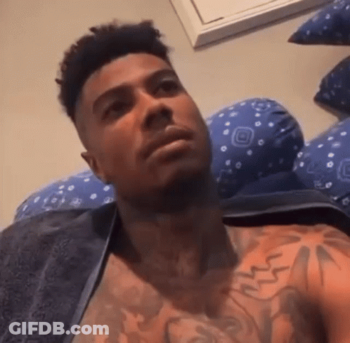 Shirtless Man With Chest Tattoo Laying On Bed GIF