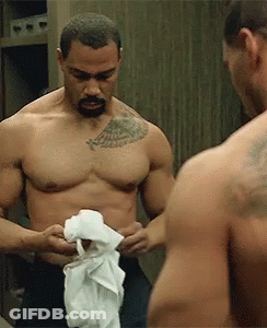 Shirtless Man With Chest Tattoo Looking At Mirror Reflection GIF