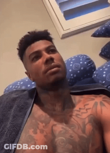 Shirtless Man With Chest Tattoos Laying On Bed With Towel GIF