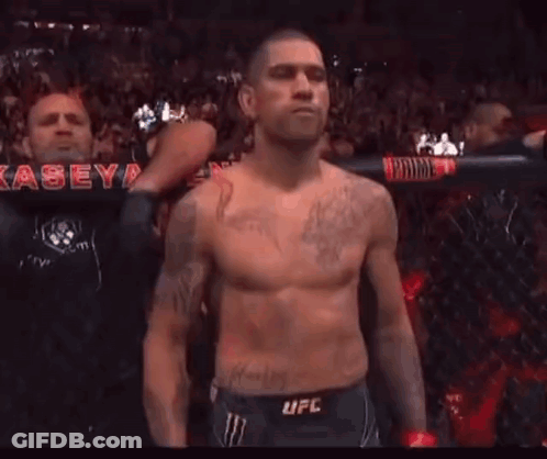 Shirtless Man With Dragon Tattoo Standing Before Crowd GIF