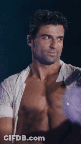 Shirtless Man With Ear Buds Looking At Something GIF