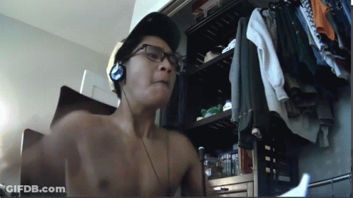 Shirtless Man With Headphones And Hat In Front Of Closet GIF