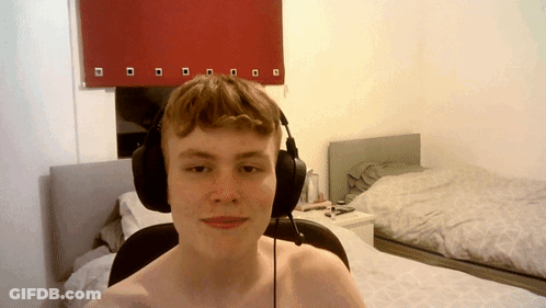 Shirtless Man With Headphones Beside Bed GIF