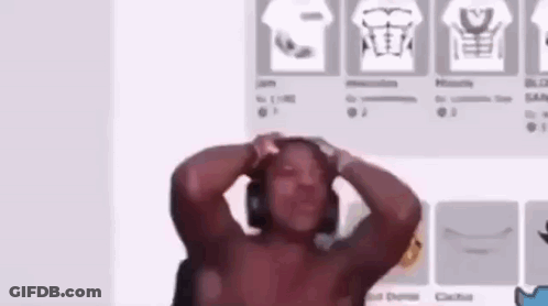 Shirtless Man With Headphones Standing In Front Of Wall With Shirts GIF
