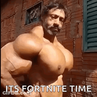 Shirtless Man With Huge Muscles In Front Of Brick Building GIF