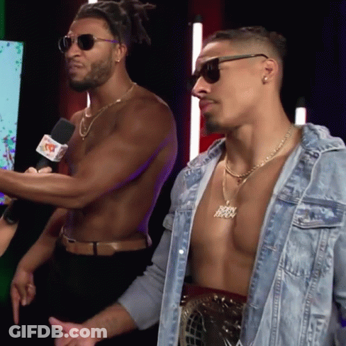 Shirtless Man With Jesus Necklace Next To Another GIF