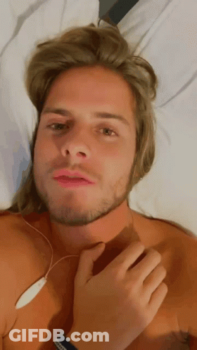 Shirtless Man With Long Blonde Hair And Beard Laying On Bed GIF