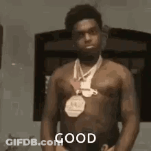 Shirtless Man With Medal Before Mirror GIF