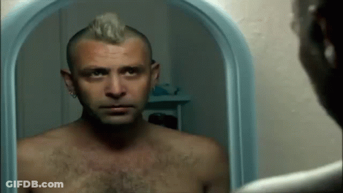 Shirtless Man With Mohawk Looking At Mirror GIF