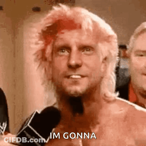 Shirtless Man With Mohawk Talking Into Microphone GIF
