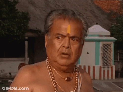 Shirtless Man With Necklace In Front Of Green Building GIF