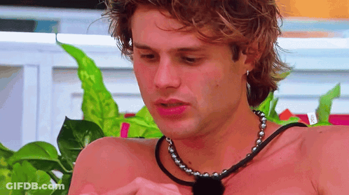 Shirtless Man With Necklace Looking Down GIF