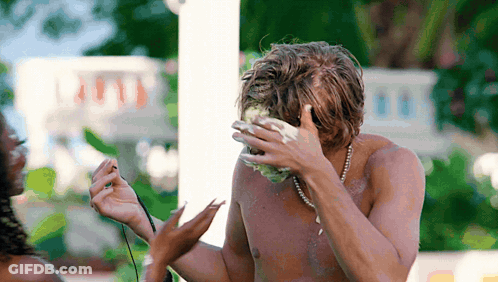 Shirtless Man With Pearl Necklace Covering Face GIF