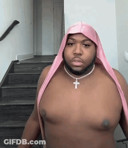 Shirtless Man With Pink Headband And Cross Necklace GIF