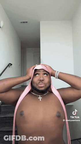 Shirtless Man With Pink Scarf And Cross Necklace GIF