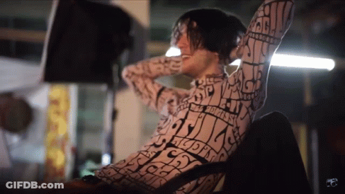 Shirtless Man With Rainbow Cape Says Happy Friday GIF