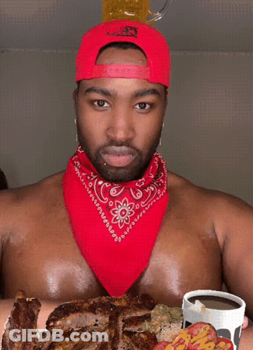 Shirtless Man With Red Bandana And Hat Holding Beer On Head GIF