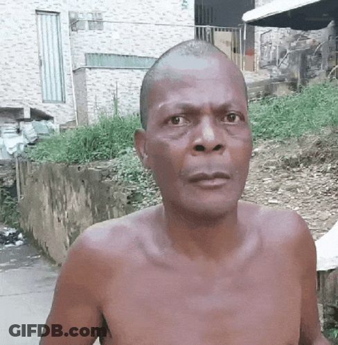 Shirtless Man With Shaved Head Looking At Camera GIF