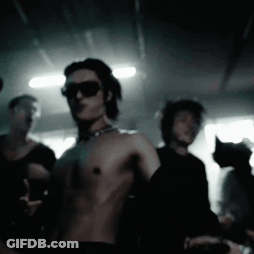 Shirtless Man With Sunglasses And Choker In Crowd GIF