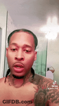 Shirtless Man With Tattoo On Chest Looking At Camera GIF