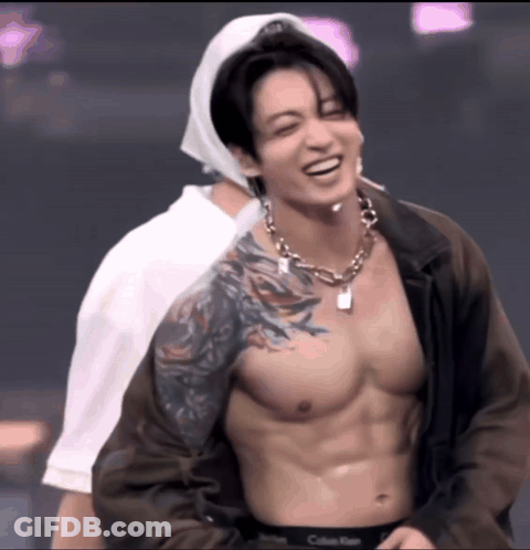 Shirtless Man With Tattoo Smiling Beside Another GIF
