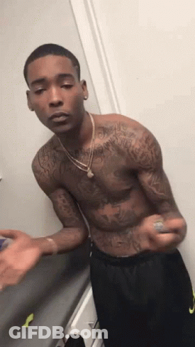 Shirtless Man With Tattoos In Front Of Door GIF