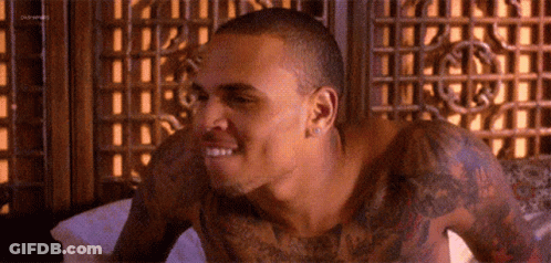 Shirtless Man With Tattoos Laying In Bed GIF