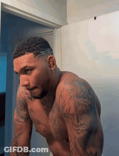 Shirtless Man With Tattoos Looking In Mirror GIF