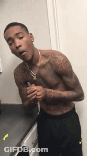 Shirtless Man With Tattoos On Kitchen Counter GIF