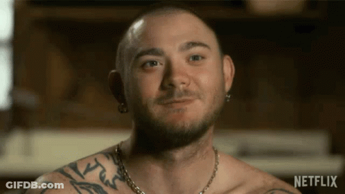 Shirtless Man With Tattoos Smiling In Netflix Video GIF