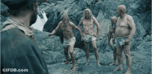 Shirtless Men Standing On Rocky Hillside GIF