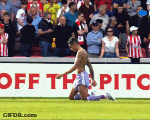 Shirtless Soccer Player Kneeling In Front Of Off The Pitch Sign GIF