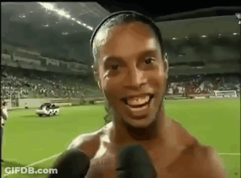 Shirtless Soccer Player Smiling Talking Into Microphone GIF