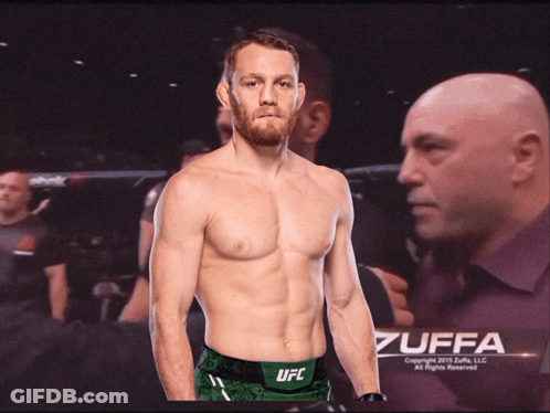 Shirtless UFC Fighter In Front Of Bald Man Poster GIF
