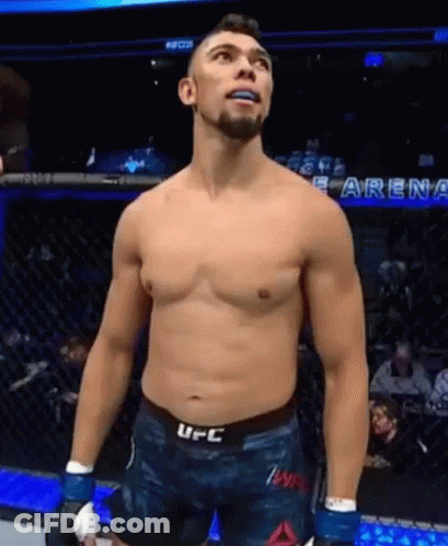 Shirtless UFC Fighter Standing In Cage Looking Up GIF