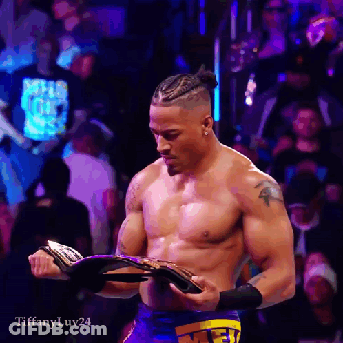 Shirtless Wrestler Holding Championship Belt GIF