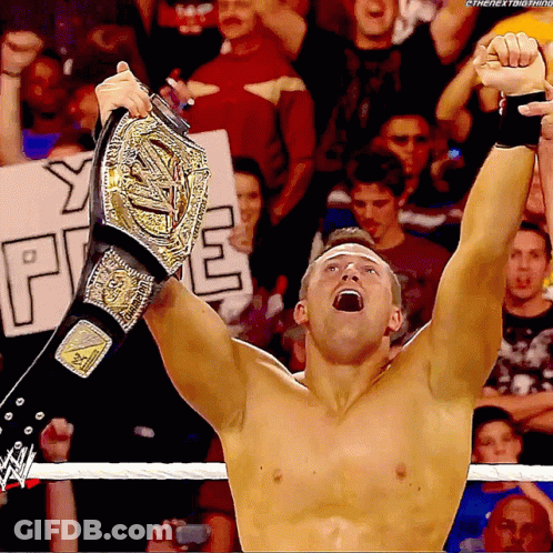 Shirtless Wrestler Holding Championship Belt GIF